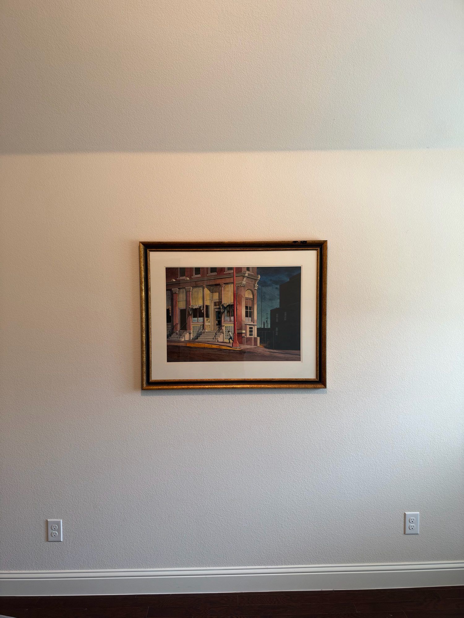 Late Evening by Floyd D. Hopper hanging framed on a white wall in a room, shown for scale.